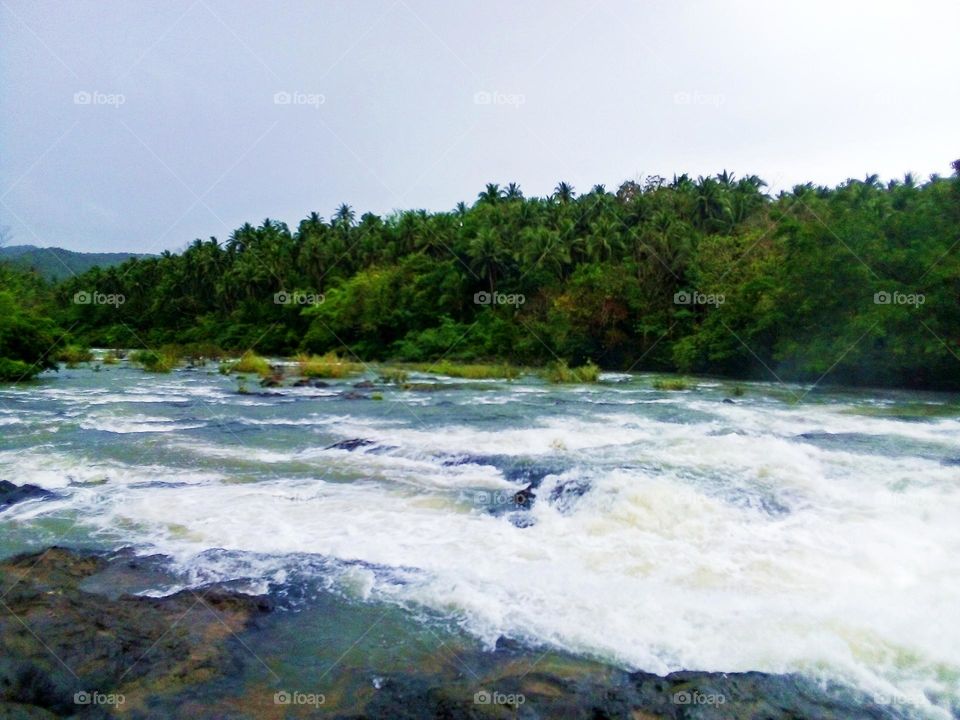 In challenging time swim with the current of a river until you reach a safer calm situation and destination.