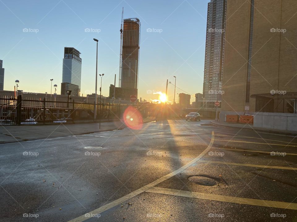 Corner of Borden Avenue and 48th Street by the water in the evening sun with colorful lens flare. 2021. Hypnotic Productions
