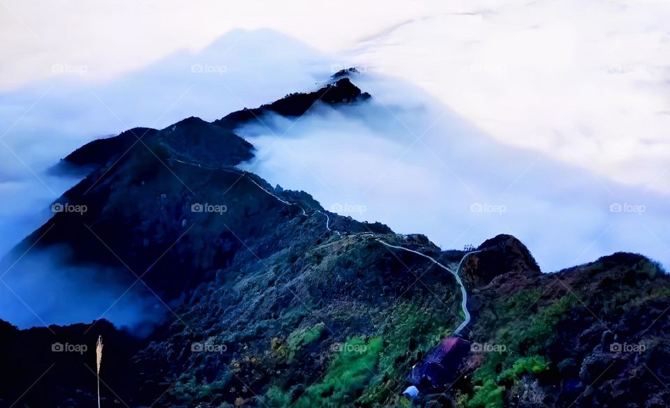 Mountains amidst clouds and mist