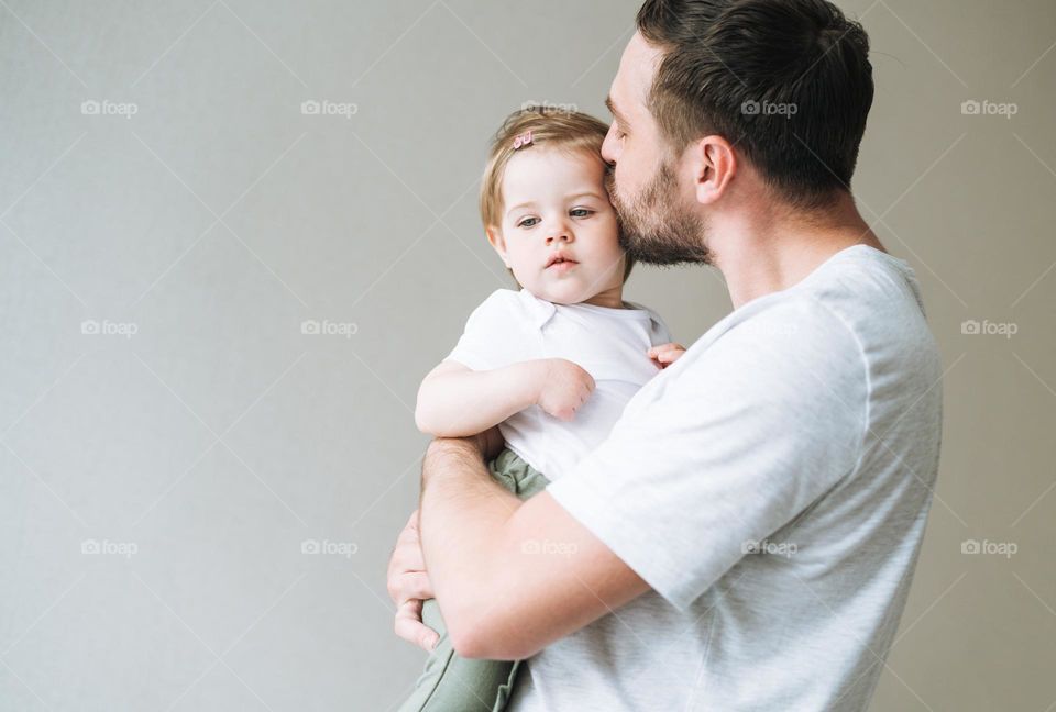 Young happy family with father and daughter having fun in cozy home, father day