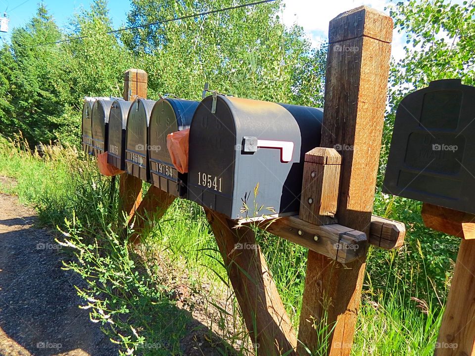 Row of mailboxes on mountainside.