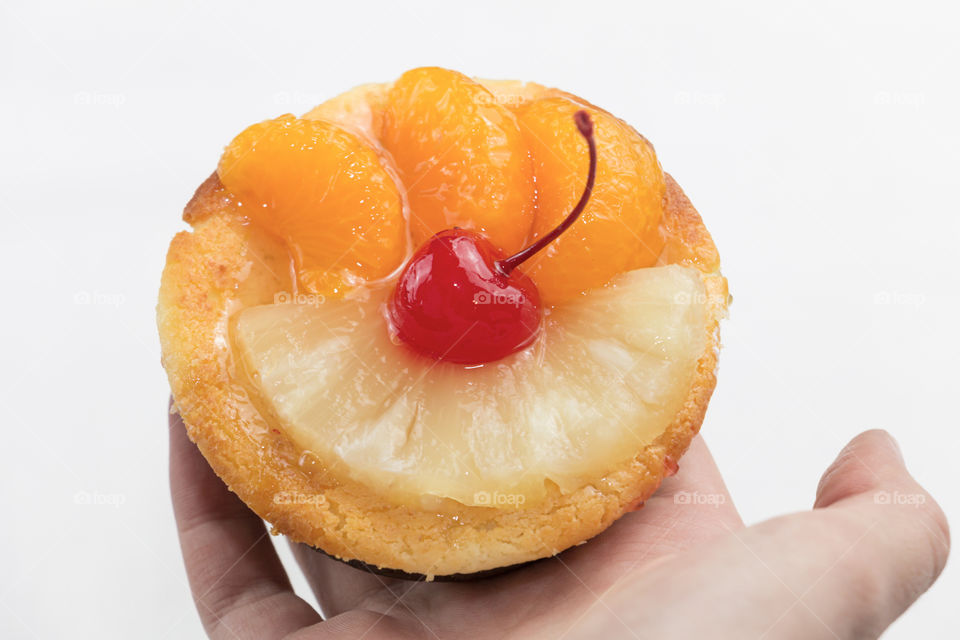 Close-up of person's hand holding fruitcake