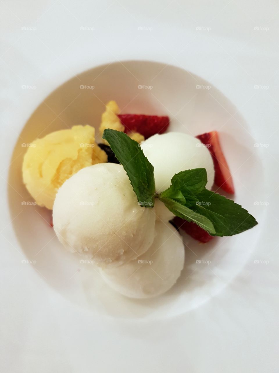 Fresh fruit sorbet dessert on a white plate