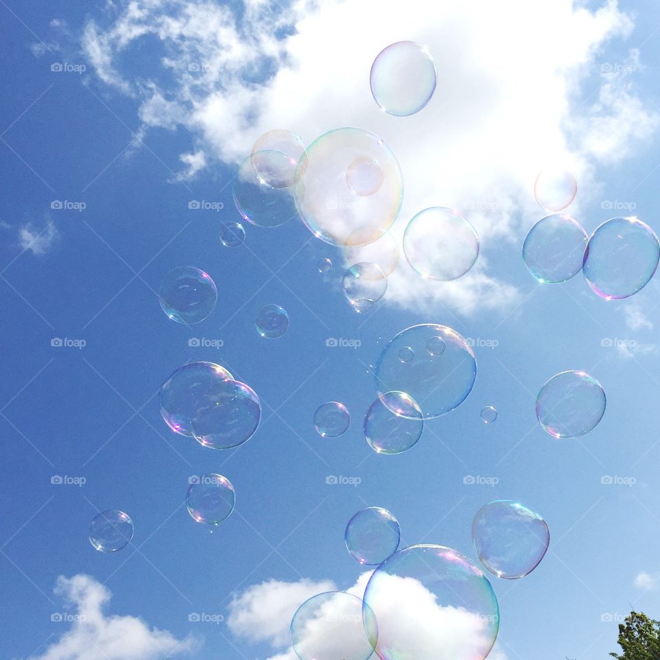 Beyond Bubbles. Bubbles and sunshine create a sky full of rainbows. 