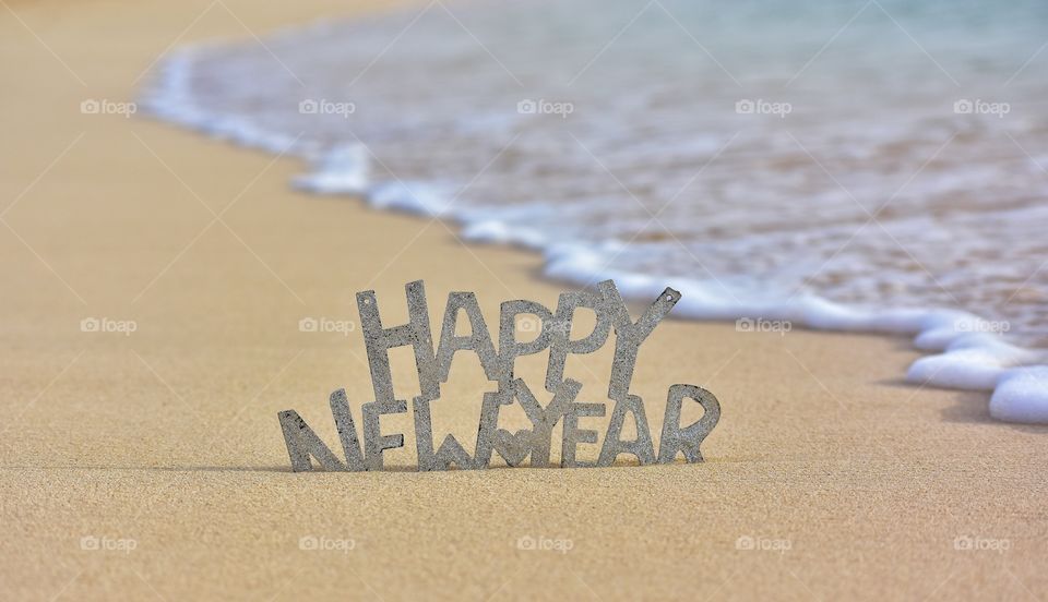 happy New year sign on the beach on fuerteventura canary island in Spain