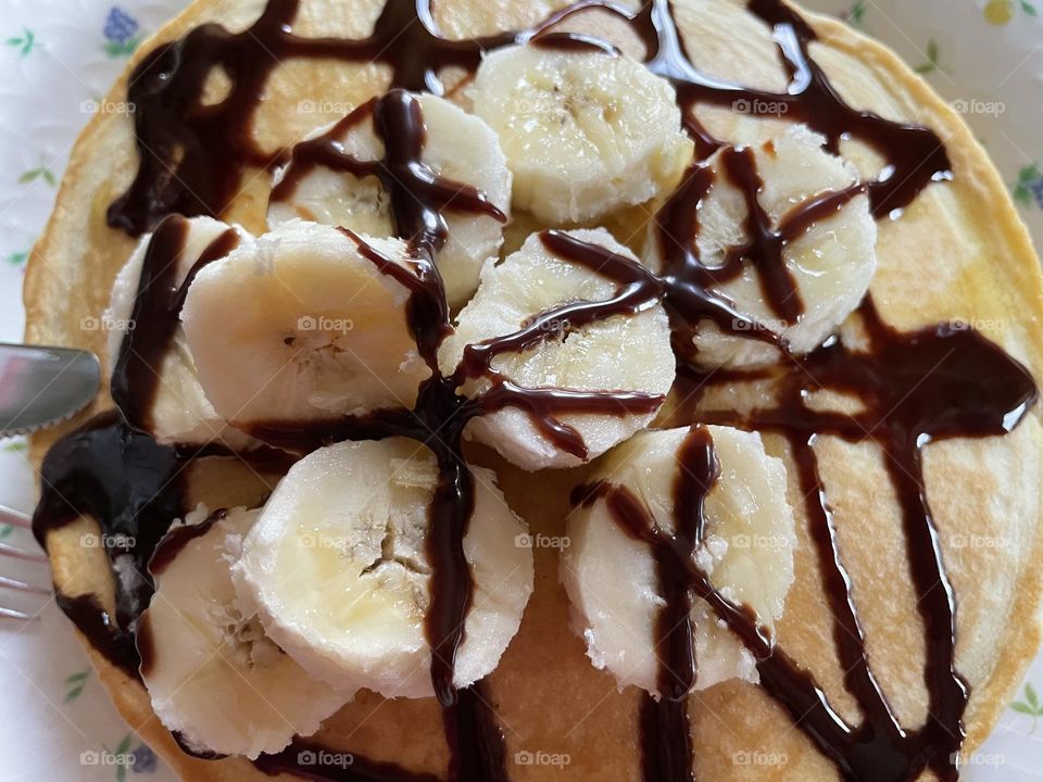 Pancakes with banana slices and chocolate sauce 