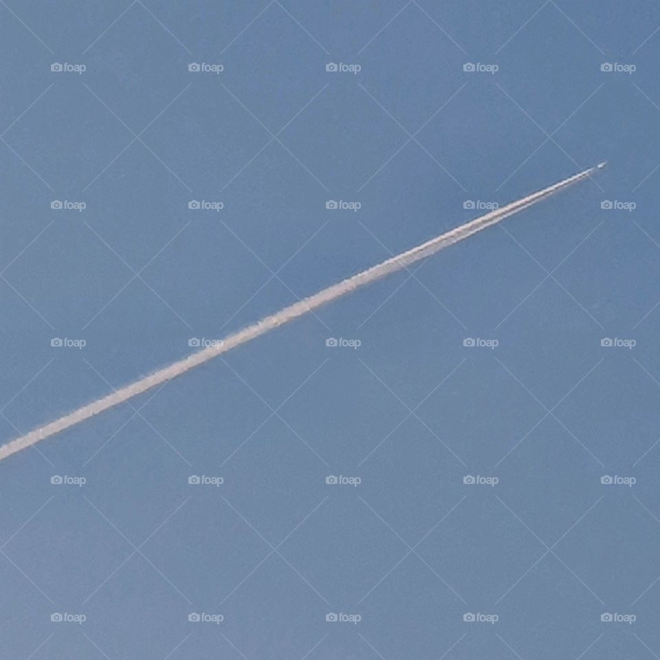 High in the sky a jet plane.