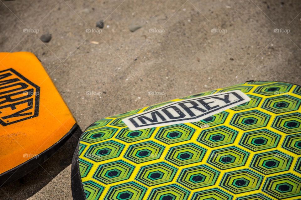 Boogie boards on the beach waiting to be enjoyed during summer vacation 