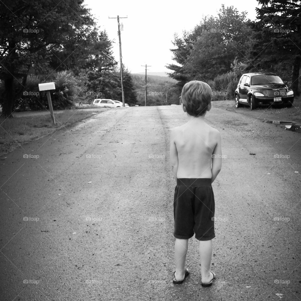 Boy in the Road. My son on a Summer evening walk on our road.