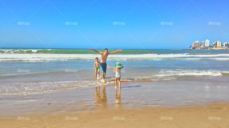 Father with children enjoying at beach