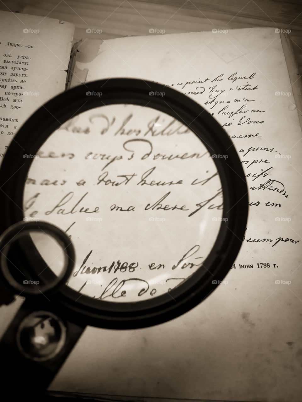 Optical phenomena.  A magnifying glass enlarges the font of the old book.  Manuscript of Catherine II