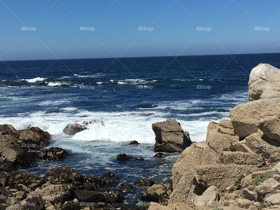 Blue sea against clear sky