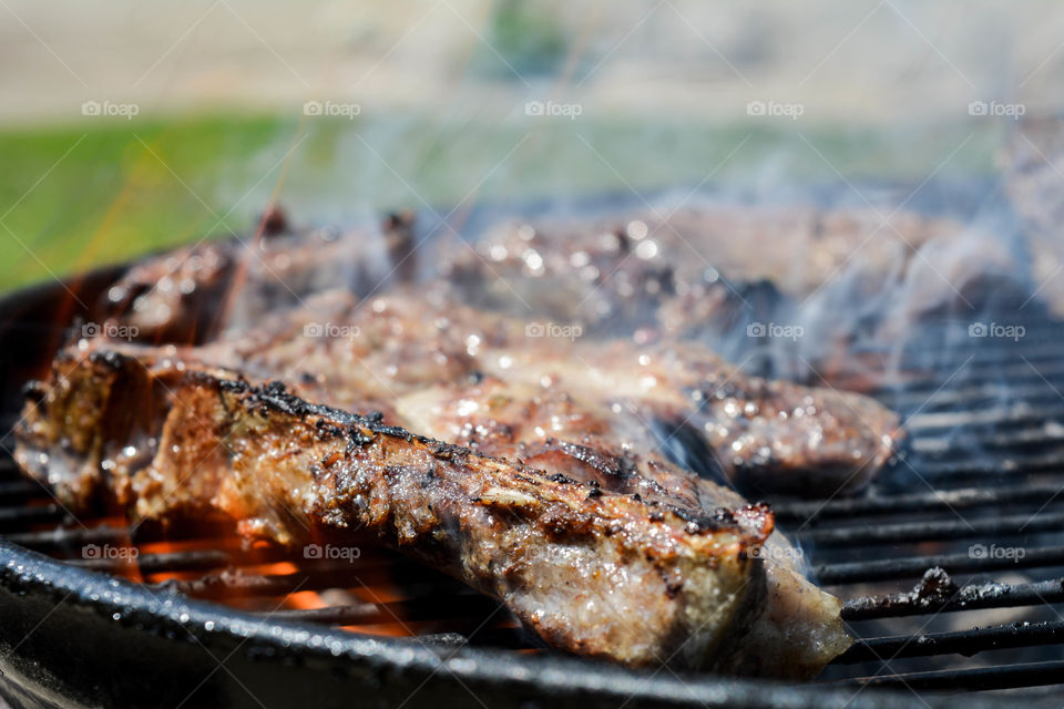 Cooking meat on barbecue grill