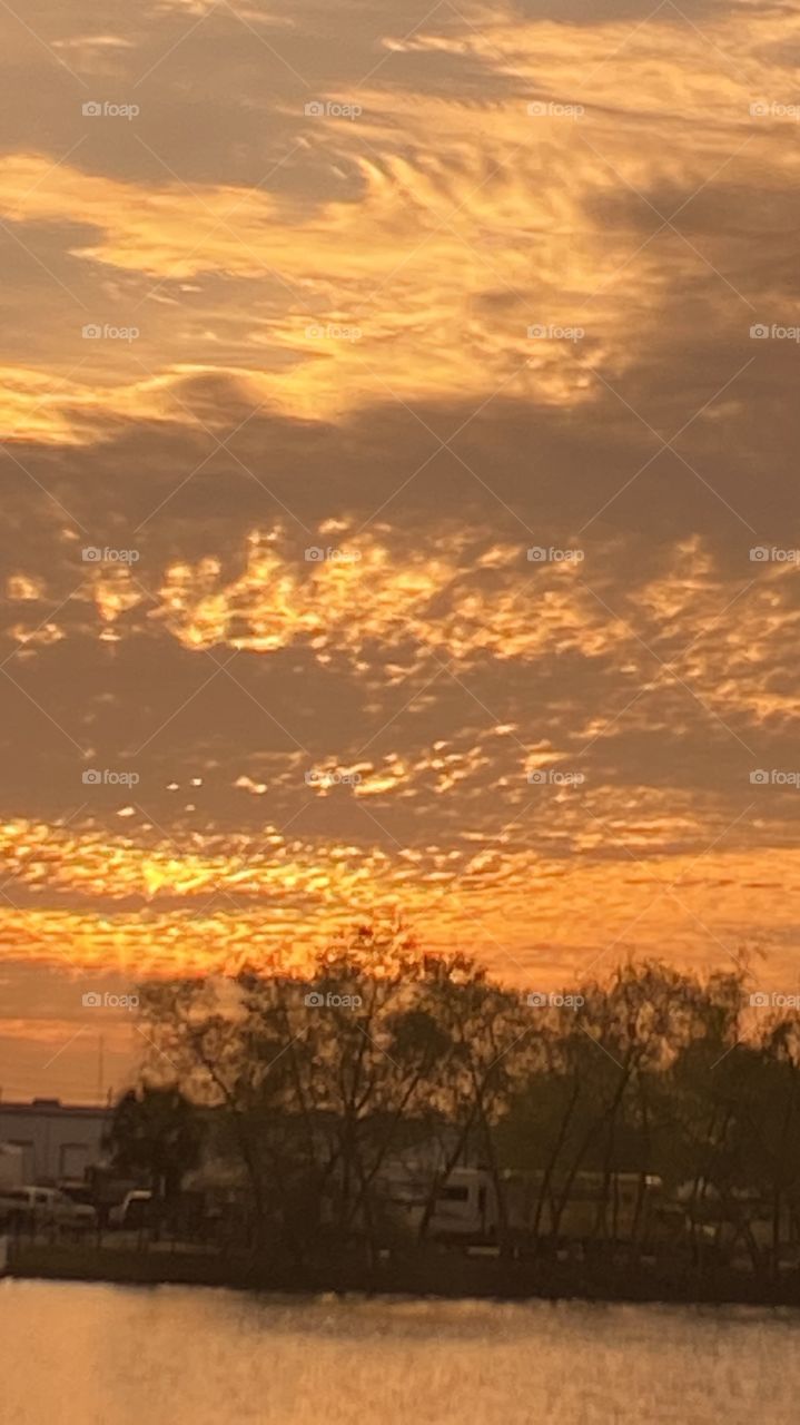 Early evening sunset with 2 separate Reflections on Lake Waters. Evening colors present but lots of clouds also present. So so for good sunset pics.