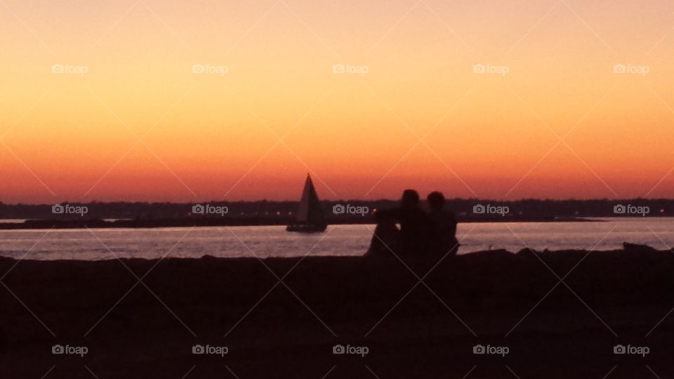 couple watching sunset harbor. erie basin marina Buffalo ny