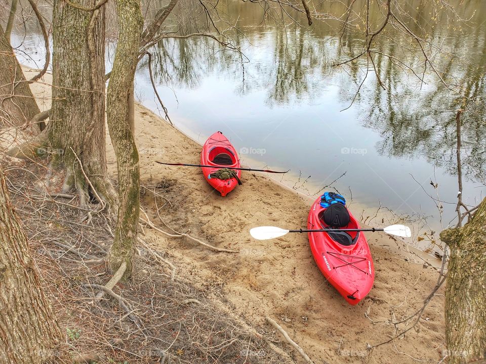 two kayaks on river Bank