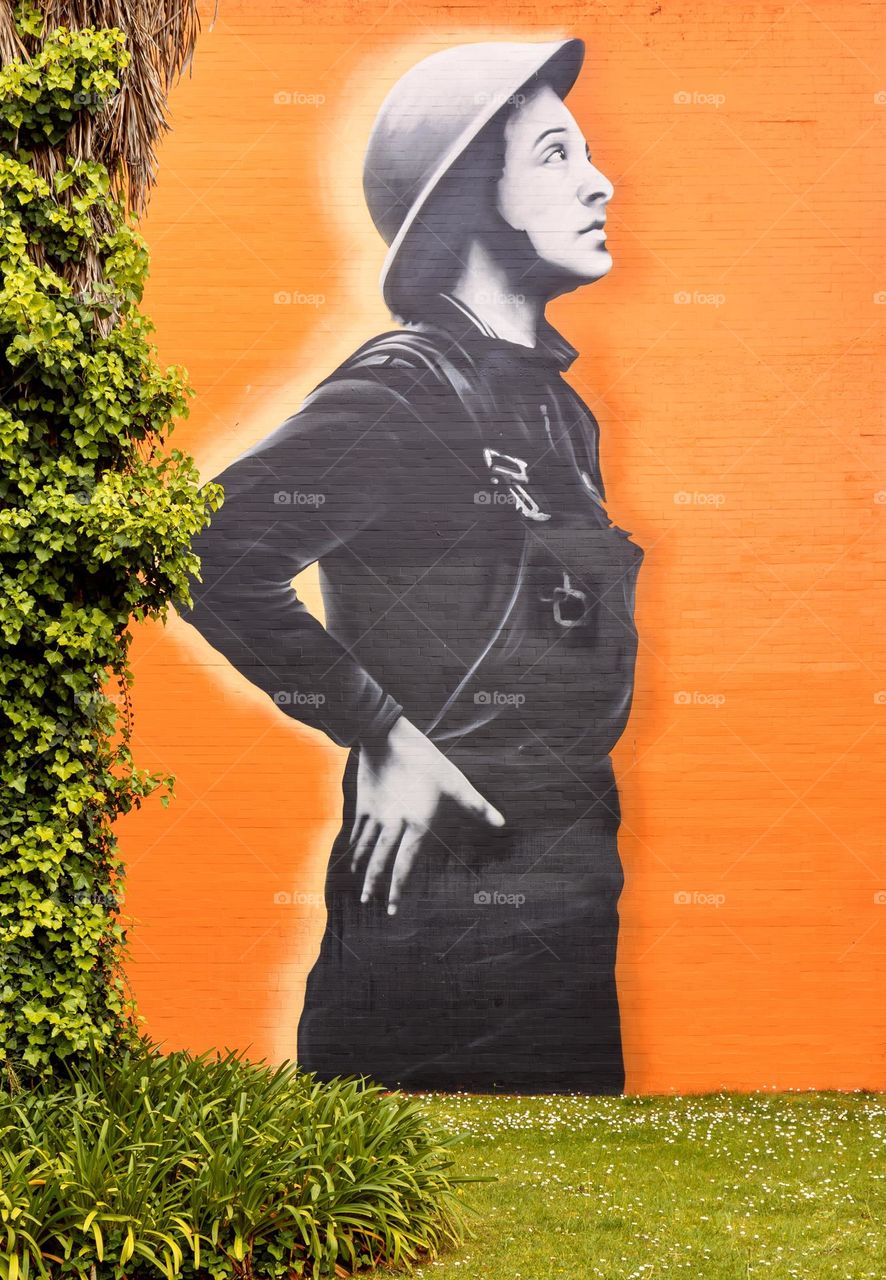 Orange mural surrounded by green foliage