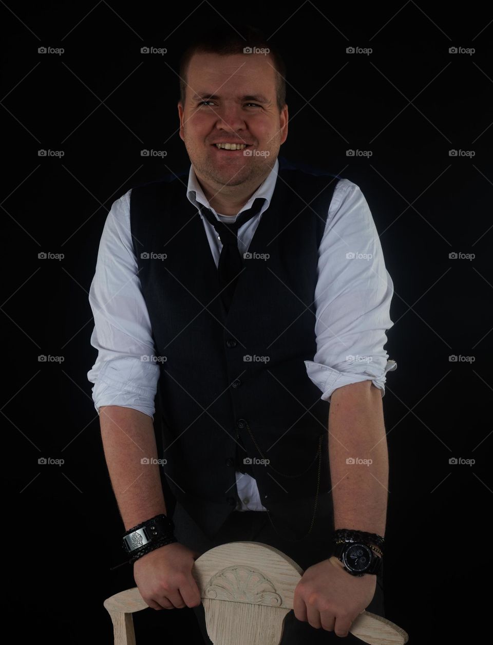 A smiling and happy man in the photo studio for some weeks ago. Dark backgrround but lighten up smile .