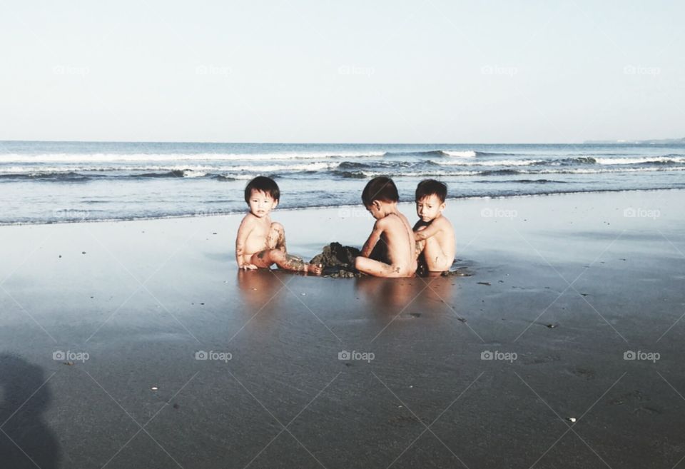 Group of asian children playing at beach