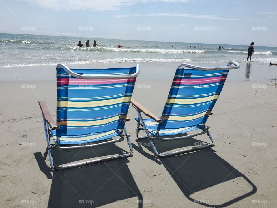 Beach chairs. Two beach chairs along the shoreline in Myrtle Beach South Carolina