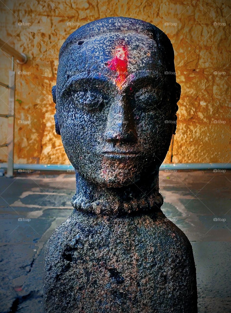 Human like Stone sculpture, at first sight it looks like a real boy meditating after few minutes we realises it's a statue, an amazing example of ancient Indian architecture