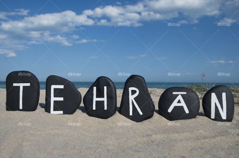 Tehran, capital of Iran on black stones