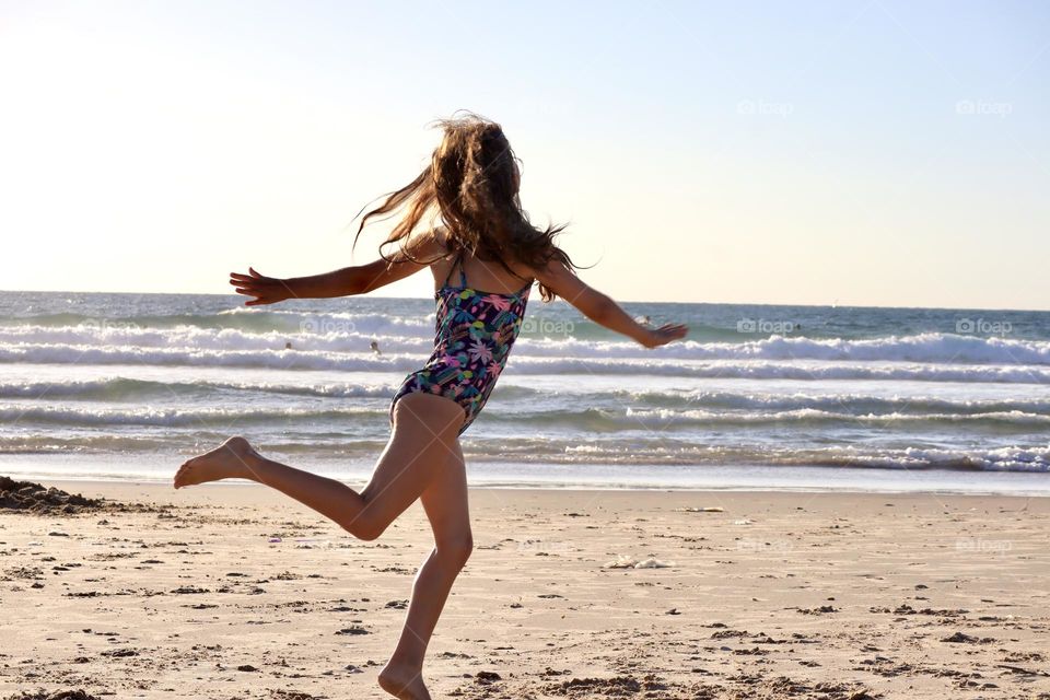 Girl dancing on the beach 