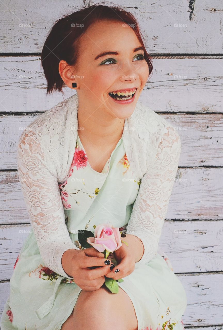 Smiling girl in a cute dress with flowers on