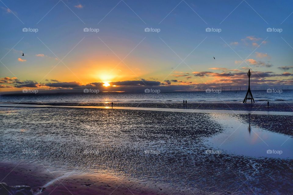 Scenic view of beach at sunset