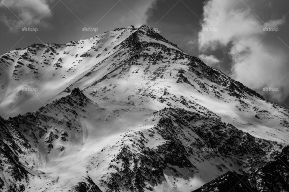 Snowy mountain peak in China, zoomed in photo of a mountain, snowy mountain view in black and white