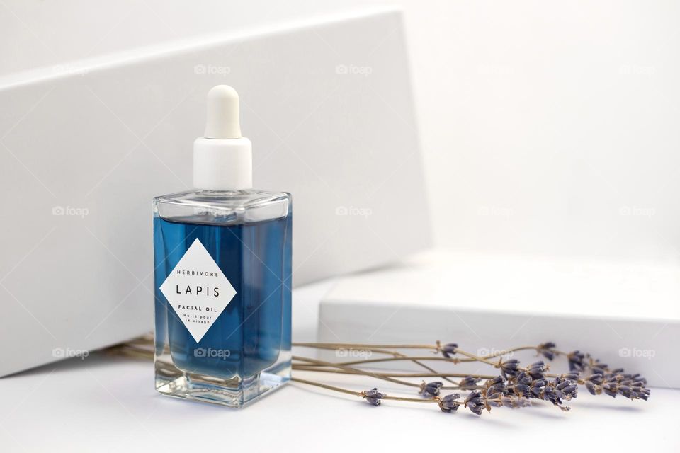 Blue face oil on the white background 