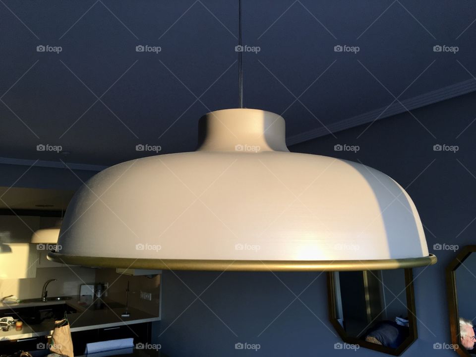 Sun lighting a ceiling lamp 