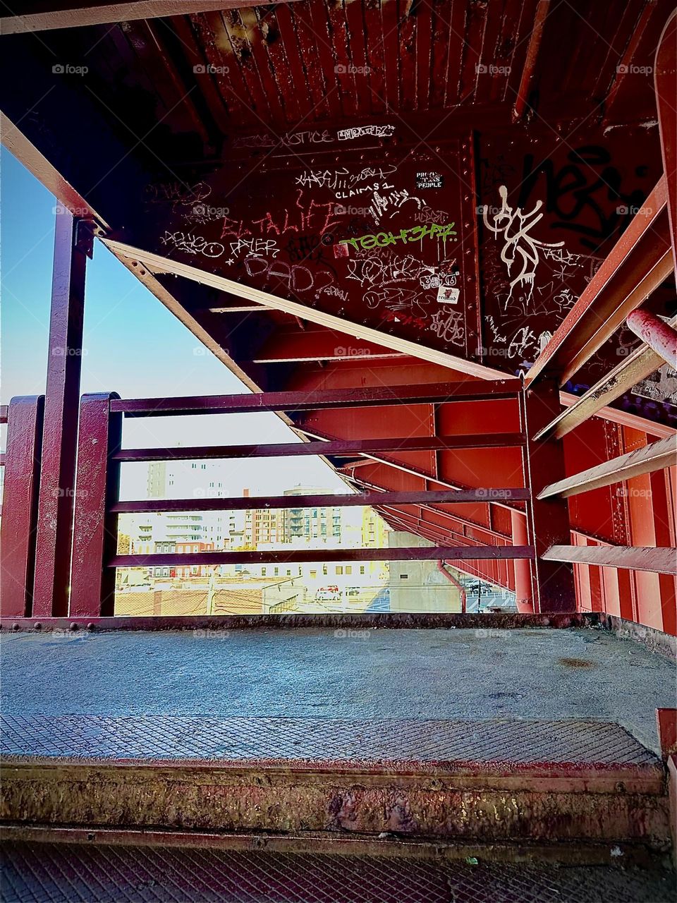 This is the red metal staircase of the “Pulaski Bridge” at “Newtown Creek” in LIC, Queens leading up to the pedestrian lane to cross over to “Greenpoint”, Bklyn. 2023. Hypnotic Productions