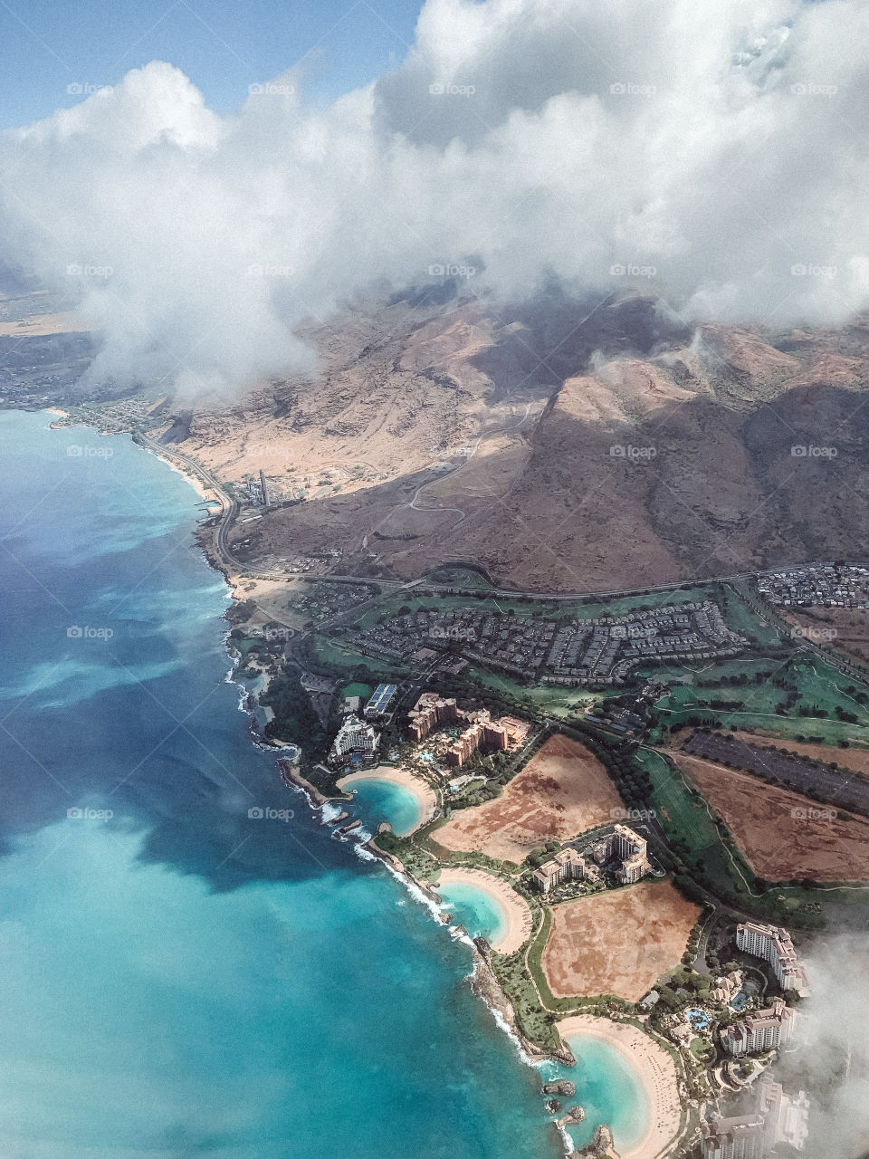 An aerial view of the west side of the Hawaiian Island, Oʻahu. Seen from an airplane ride over the Pacific Ocean.