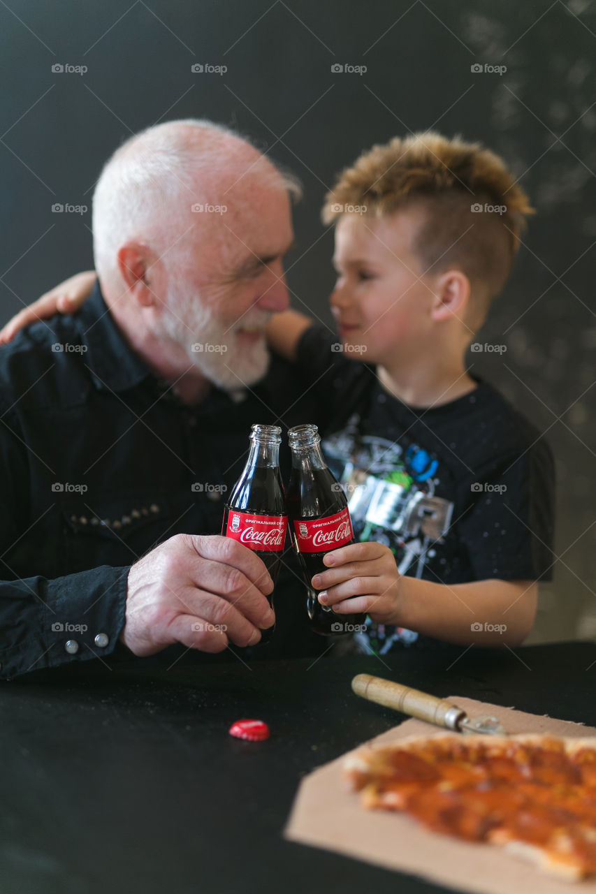 Happy grandfather and grandson. Spent time together at home. Black style 