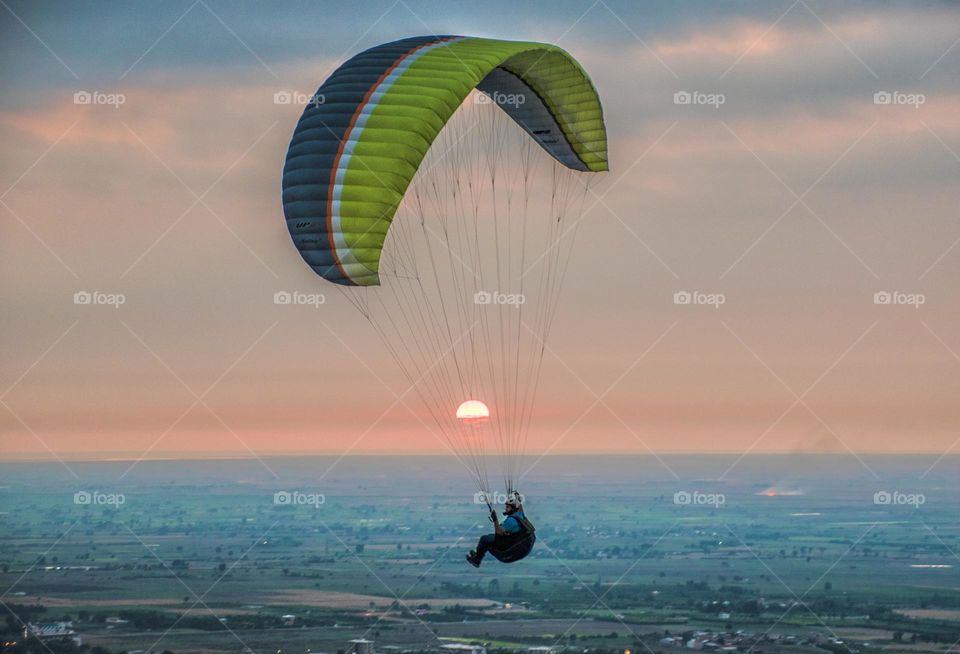 Paragliding riding on the sun