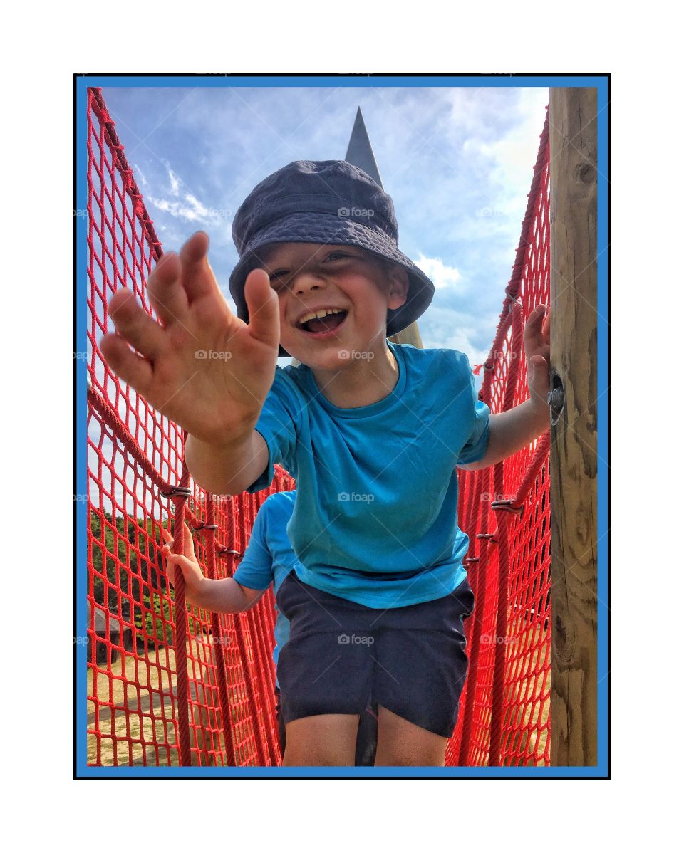 Small child standing near railing
