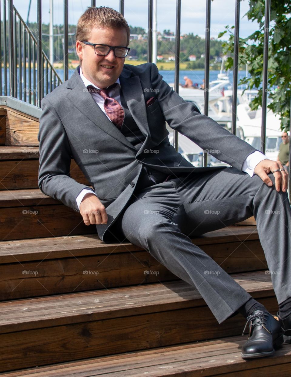 A young man portrait in a stars outdoor . 
Relaxing with a suite and tie.
a very normal day