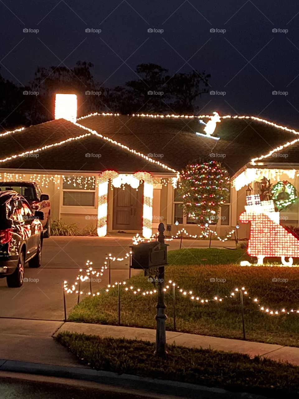 A family’s home is lit up in colorful Christmas lights. 