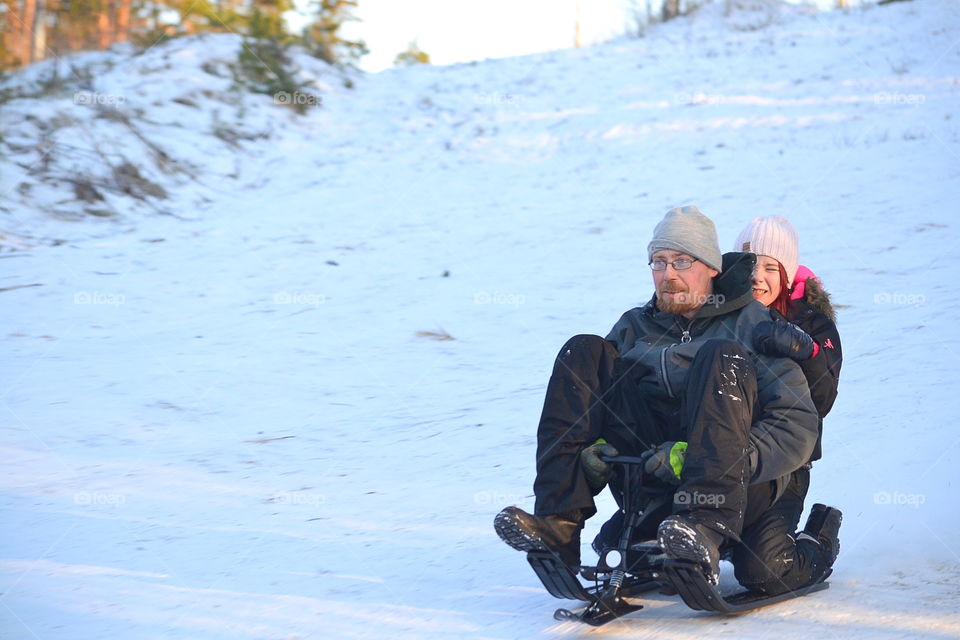 Father and daughter sledding