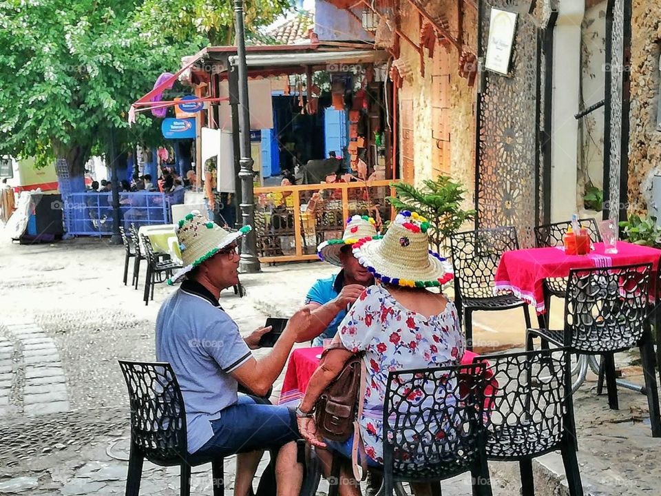 People sitting on a terrace cenjoying a rest, surrounded by vibrant colors