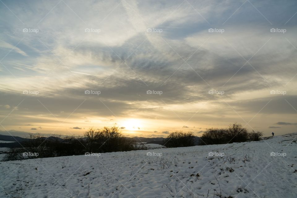sunset on meadow during winter