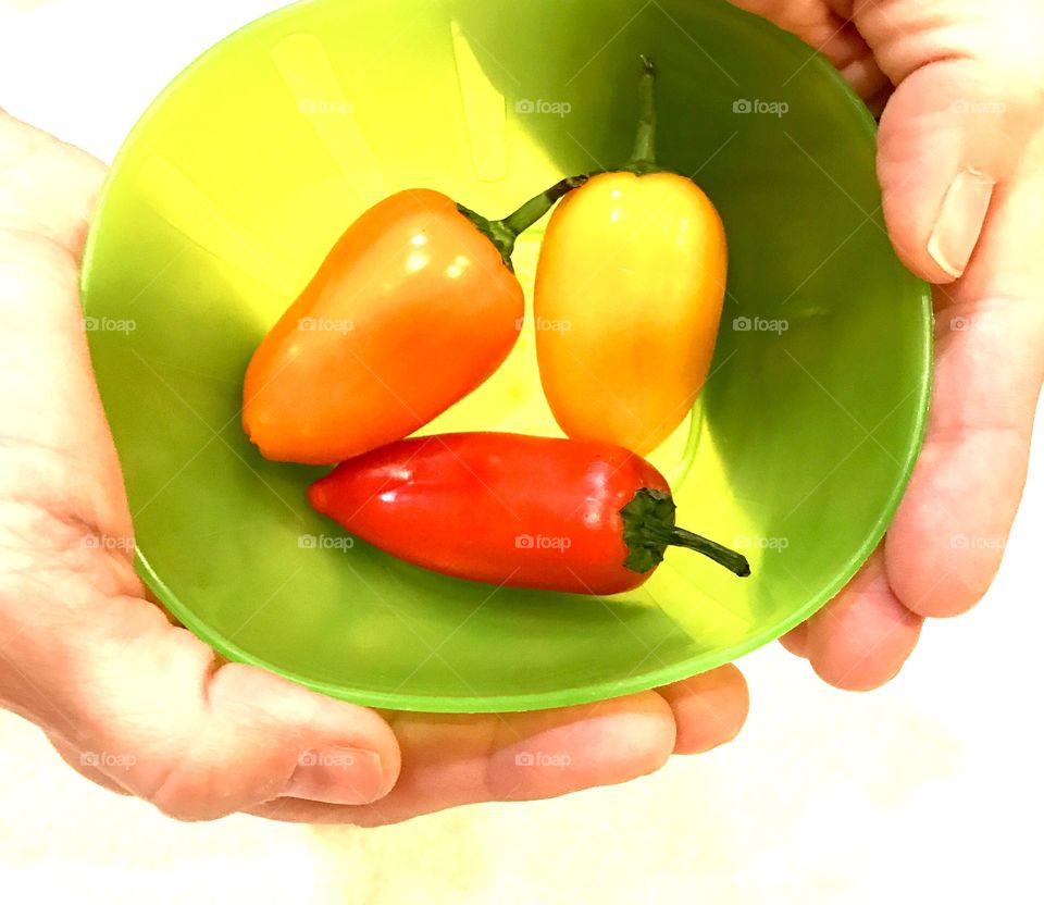Hands & Bowl of Peppers
