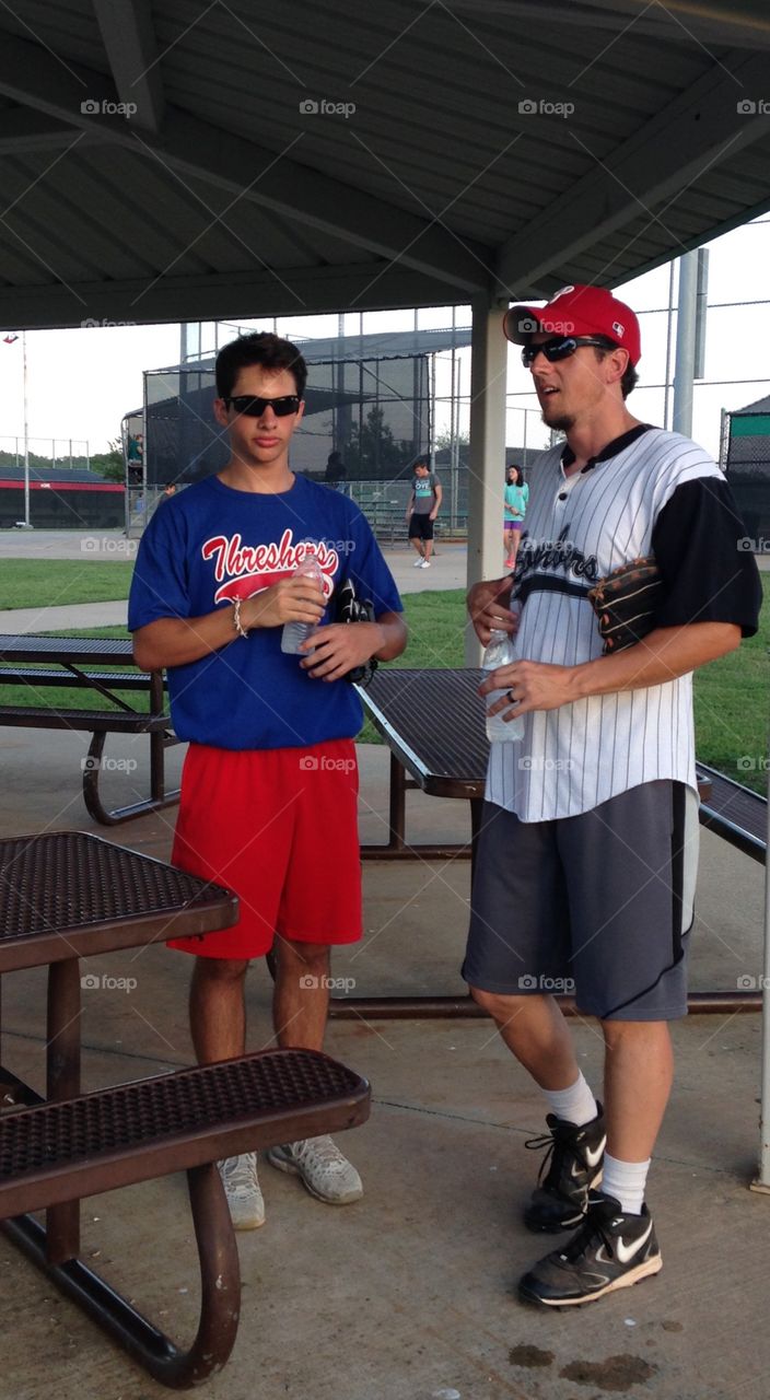 Father/son softball talk. Father and son talking about the softball game they played