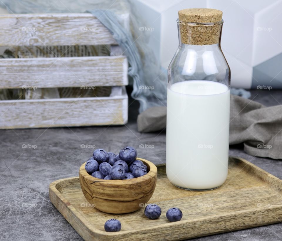 Bottle with milk and blueberries