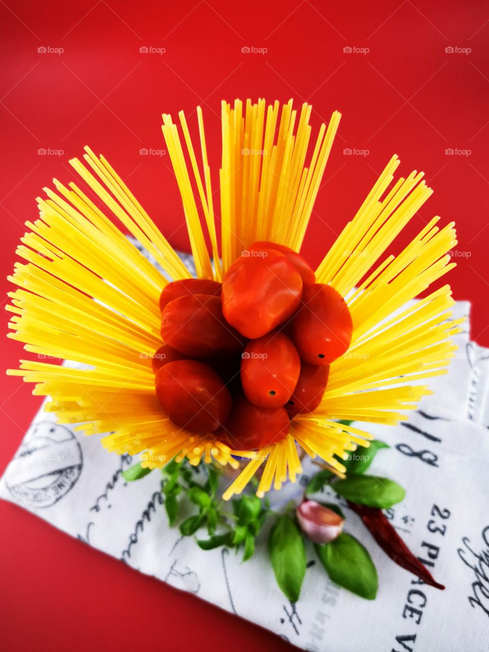 Directly above Shot of raw Spaghetti in the Kirchen Tower with tomatoes, Basil and garlic.