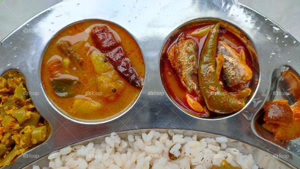 Healthy and tasty Indian Meal, Beautiful presentation of Indian food, spicy foods, vegetarian and non-vegetarian food, Rice Thali,best food, tasty foods, fish curry, sambar, lemon pickle