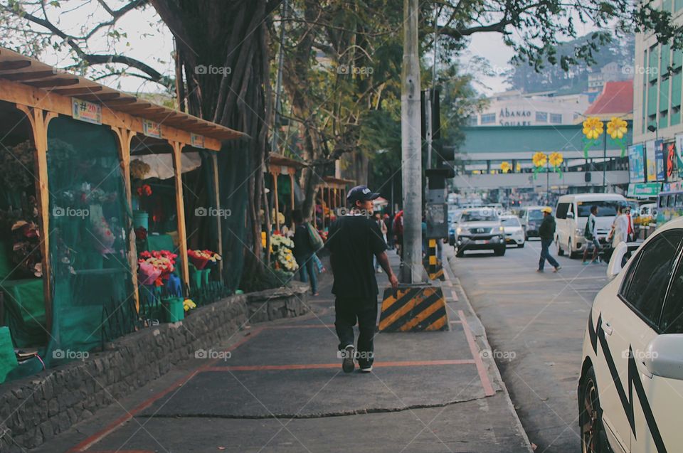 Man walking on the sidewalk.