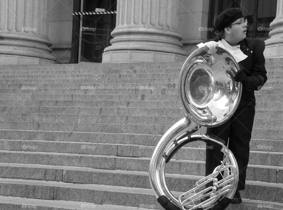 A tuba player standing on the steps of the Foley Post Office Building after marching in the 2019 Macy’s Day Parade