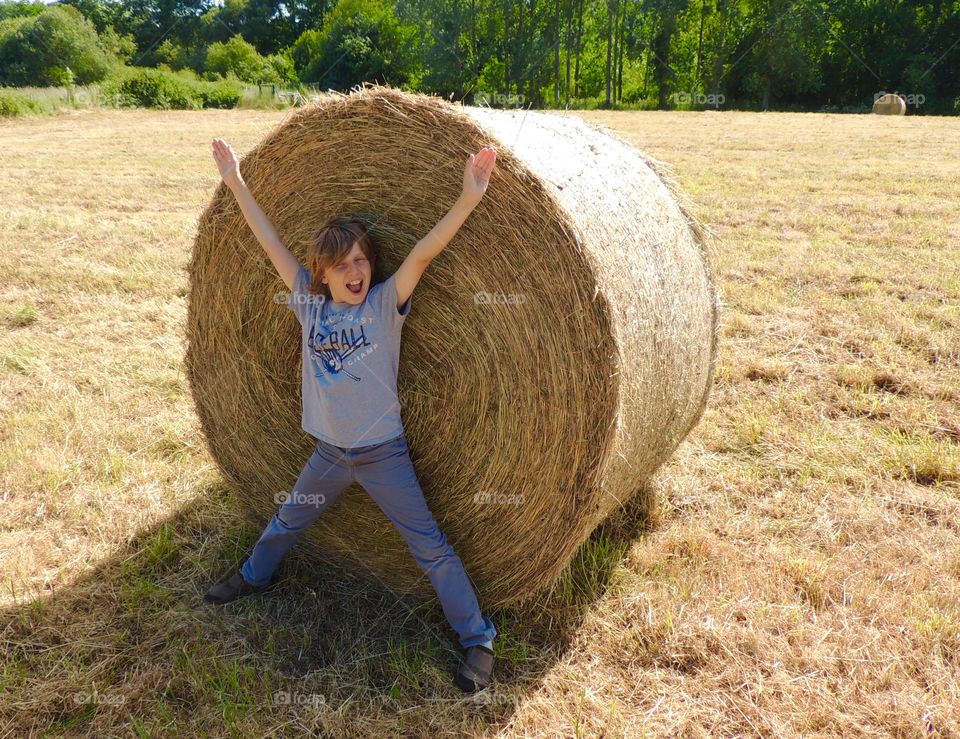 Fun in the hay. . My son enjoys himself during hay making. 